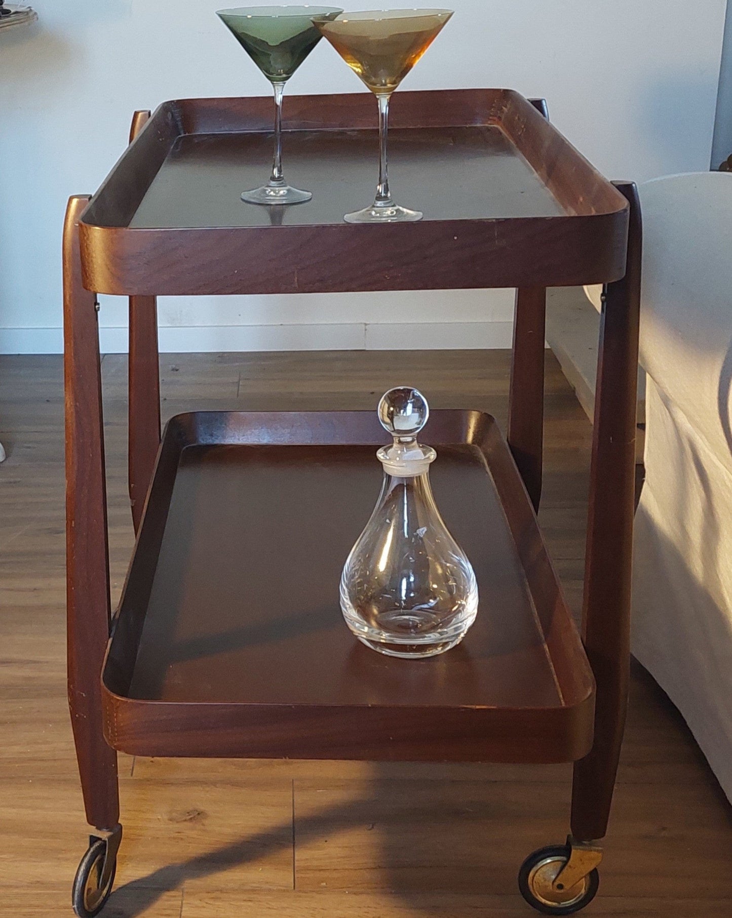 trolley by a sofa with glasses