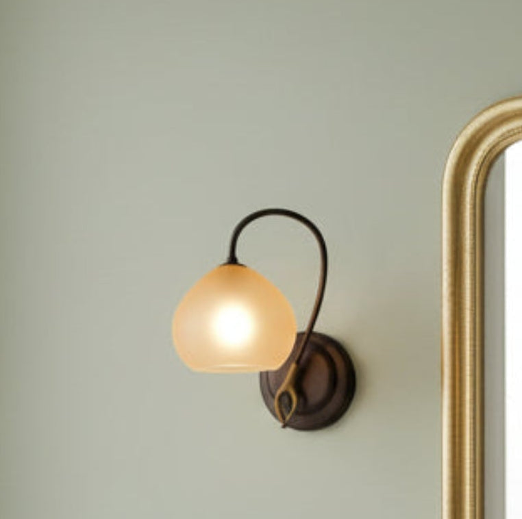 Small  Marchetti lamp with a glowing bulb  by a mirror