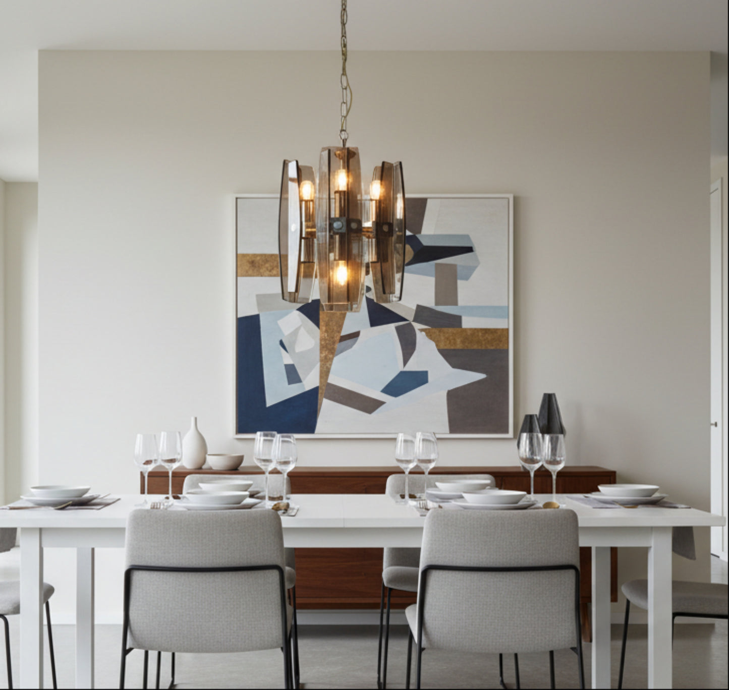 mid century glass lamp over a modern dining room table with an abstract painting