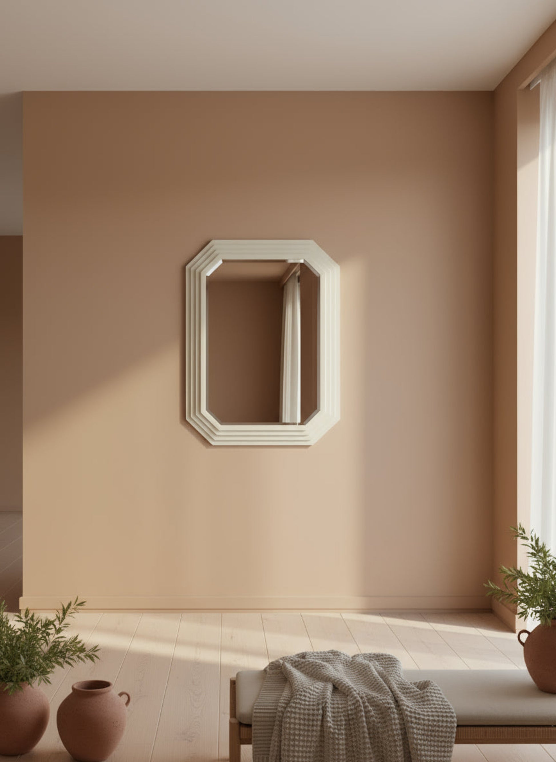 Decorative mirror on a beige wall with plants and a bench in the foreground