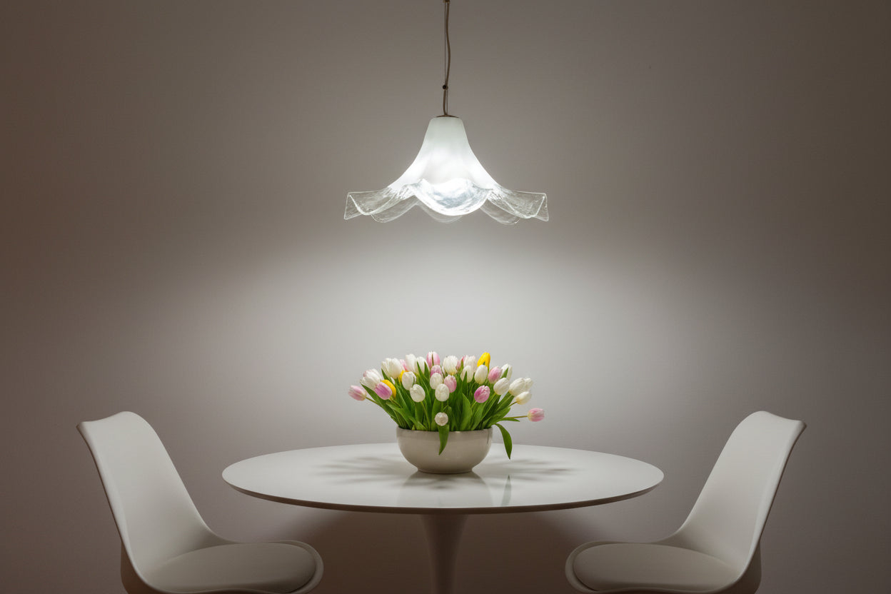 Vintage-style  La Murina pendant light with scalloped glass shade hanging from a ceiling.