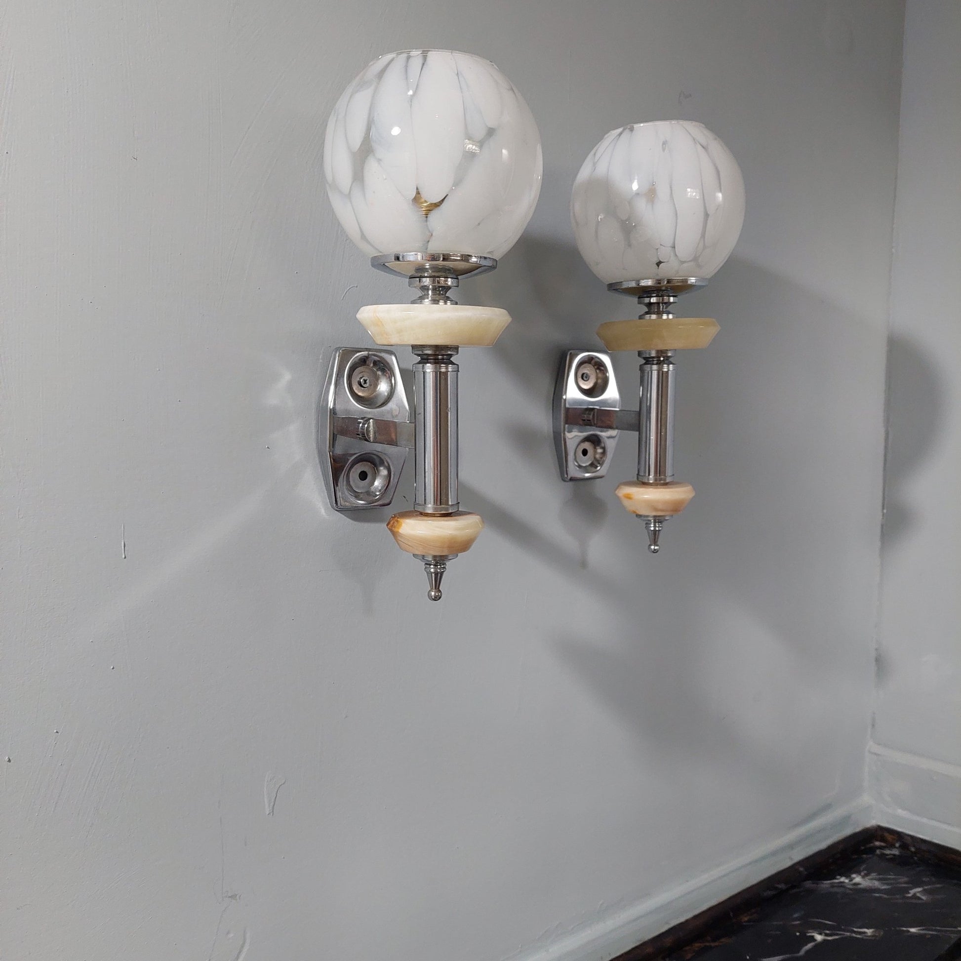 pair of deco style wall lights  on a bathroom wall