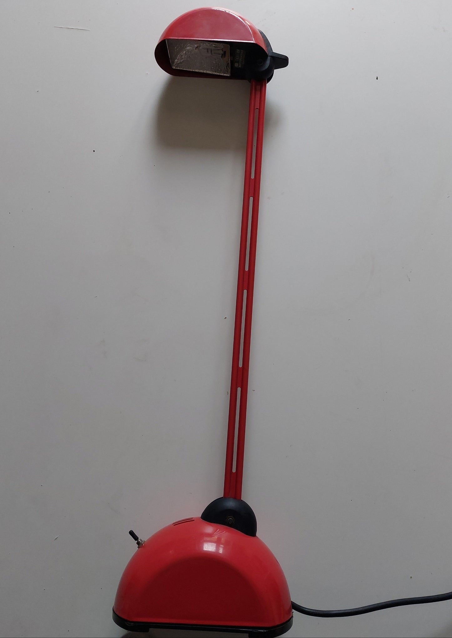 Red lamp with long neck on a white background